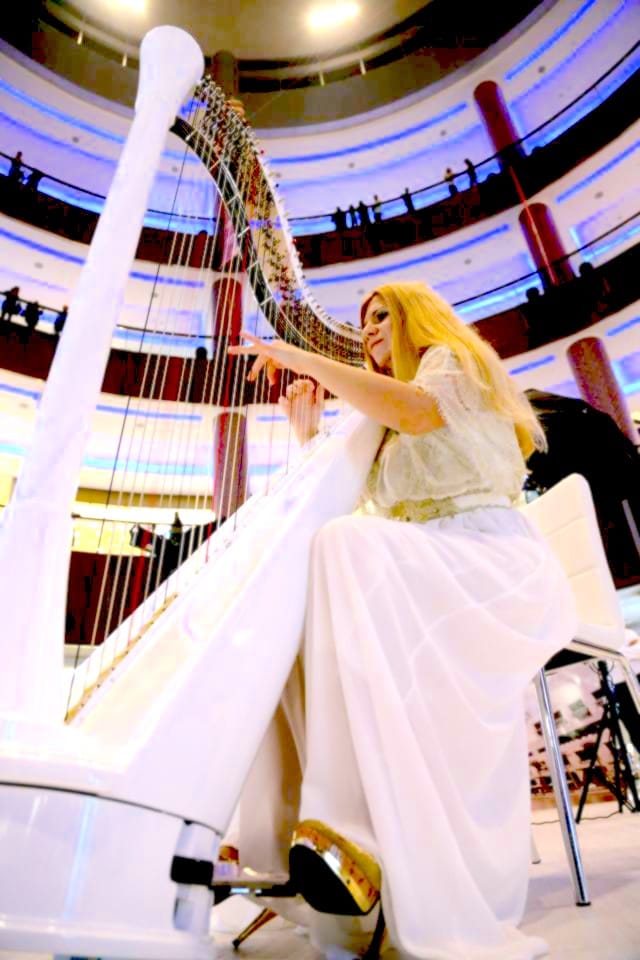 Female harp player in Dubai