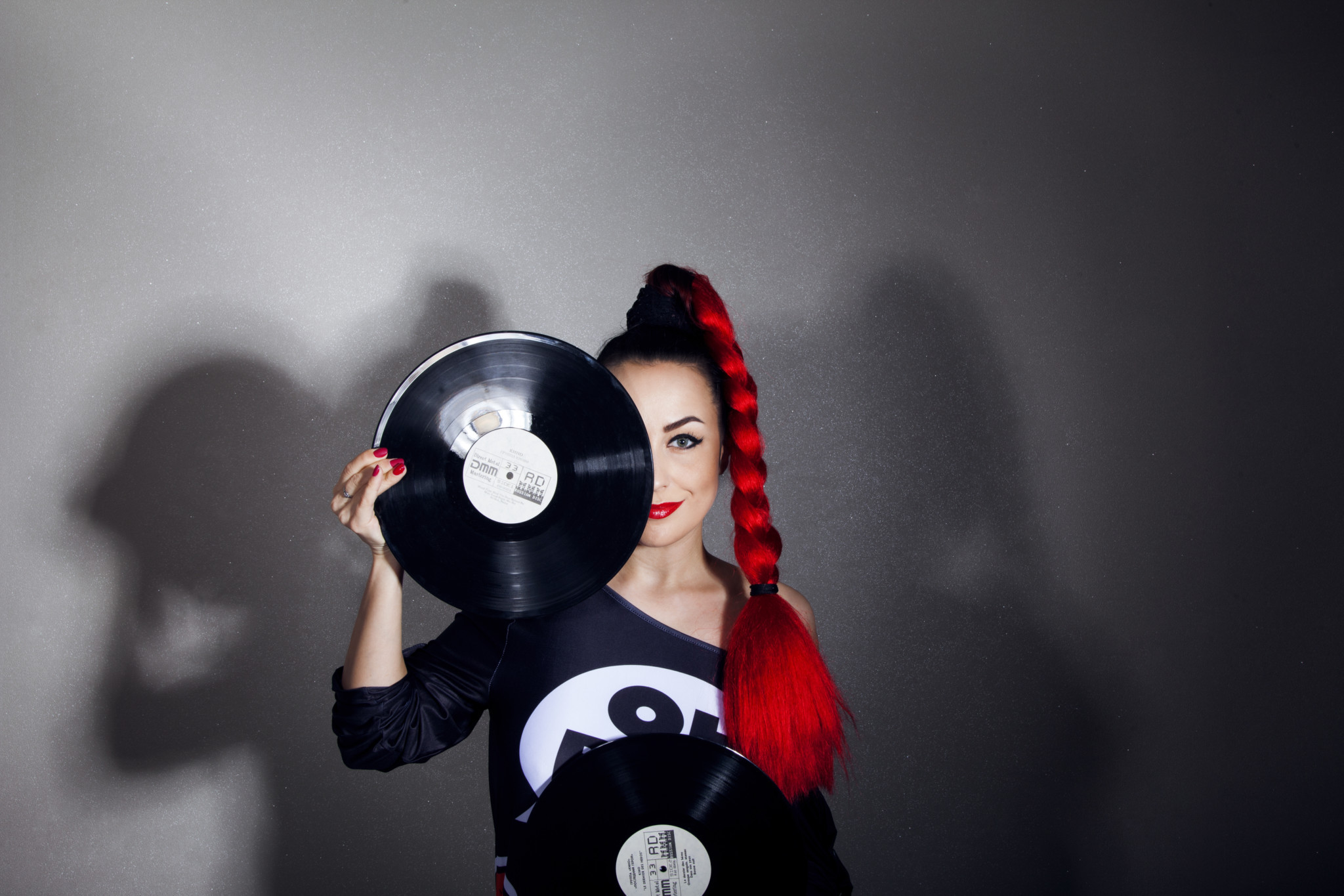 Female DJ holding record to her face