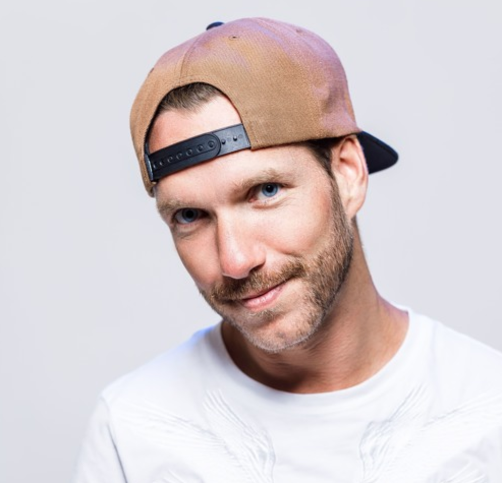 Male DJ wearing baseball cap