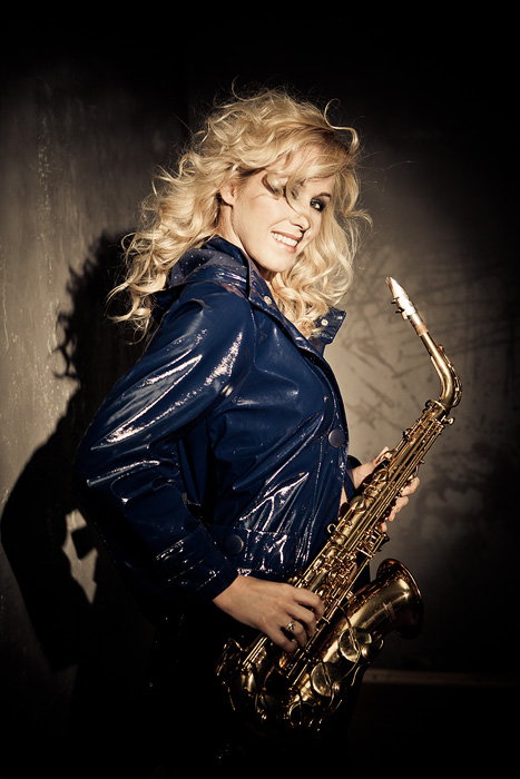 female saxophone player with leather jacket